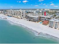 Stunning aerial view of beachfront condo with pristine sands and turquoise waters at 14900 Gulf Blvd # 304, Madeira Beach, FL 33708