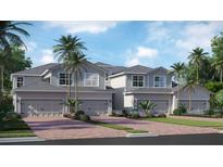 Beautiful townhome exteriors featuring modern design, two-car garages, and tropical landscaping, creating curb appeal at 17745 Boracay Ct # 19-202, Venice, FL 34293