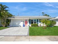 Charming single Gathering home featuring a colorful front door, updated pavers, and a well-manicured lawn at 3715 98Th N Ave # 3, Pinellas Park, FL 33782