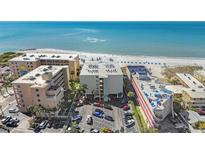 Beautiful beachfront condo buildings with a parking lot and direct beach access at 12924 Gulf Blvd # 110, St Petersburg, FL 33708