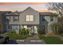 Charming two-story townhouse featuring neutral siding and a well-manicured front yard with lush landscaping at 16143 Rambling Vine E Dr, Tampa, FL 33624