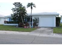 Charming single-story home showcasing its well-maintained exterior, lovely landscaping and attached one-car garage at 3710 98Th N Ave, Pinellas Park, FL 33782