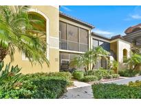 Beautiful condominium exterior featuring screened in porch with a lush landscaped walkway at 7305 River Hammock Dr # 204, Bradenton, FL 34212