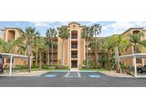 Beautiful condo building featuring multiple balconies and lush landscaping with covered parking spaces at 8403 Grand Estuary Trl # 204, Bradenton, FL 34212