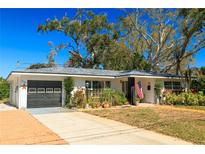 Charming single-story home with a well-maintained lawn, inviting entrance, attached garage and lush landscaping at 1131 60Th Ave S, St Petersburg, FL 33705