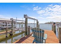 View from the private dock featuring a chair and boat lift at 249 Shore Dr, Palm Harbor, FL 34683