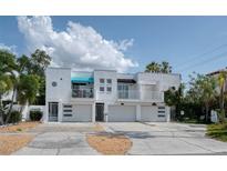 Contemporary three-unit building showcasing modern design with balconies and individual garages at 3101 W El Prado Blvd # B, Tampa, FL 33629