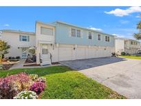 Charming two-story townhouse featuring attached garages and vibrant landscaping at 3280 39Th S St # B, St Petersburg, FL 33711