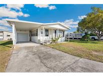 Charming single-story home featuring an attached carport and well-maintained landscaping at 35145 Garber Ln, Zephyrhills, FL 33541