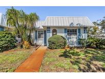 Charming single-story home with well-maintained landscaping, vibrant lawn and metal roof at 4215 Regal Pl, New Port Richey, FL 34652