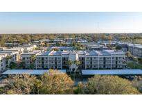 Wide aerial view of the condo community, with lush landscaping and well-maintained buildings at 8681 Bardmoor Blvd # 208C, Seminole, FL 33777