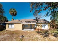 Charming single story home with stucco exterior, well-maintained landscaping, and attached one car garage at 924 N Castle Ct, Tampa, FL 33612