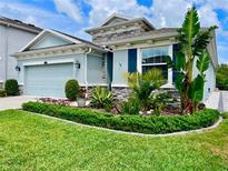 Charming home featuring lush landscaping, stone accents, and a well-maintained lawn, creating curb appeal at 12503 Candleberry Cir, Tampa, FL 33635
