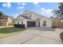 Charming two-story home features a well-manicured lawn and a convenient two-car garage at 1801 Rudder Dr, Valrico, FL 33594