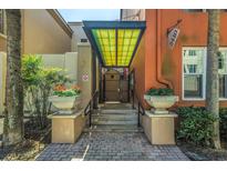 Inviting entrance with well-maintained steps, potted flowers, and a decorative awning, creating a welcoming ambiance at 2402 W Azeele St # 423, Tampa, FL 33609