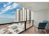 Enjoy ocean views from the condo balcony with seating and overlooks the pool deck and beach at 450 S Gulfview Blvd # 605, Clearwater Beach, FL 33767