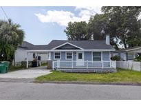 Charming single-story home featuring a cozy front porch and a convenient carport at 6906 N Lynn Ave, Tampa, FL 33604