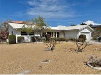 Charming single-story home featuring a white exterior and well-maintained landscaping at 701 64Th Ave, St Pete Beach, FL 33706