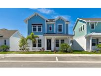 Charming blue two-story home featuring manicured landscaping and a welcoming front porch at 7258 Kodiak Ln, Sarasota, FL 34240