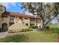 Inviting two-story condo with well-maintained landscaping and partial view of the golf course at 8003 Bardmoor Pl # 204, Seminole, FL 33777