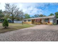 Charming single-story home featuring a brick driveway and well-maintained front yard at 9618 N 55Th St, Temple Terrace, FL 33617