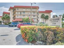Beautiful condominium building with lush landscaping and visible signage at 17580 Gulf Blvd # 302, Redington Shores, FL 33708
