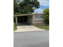 Charming single-story home with covered parking and well-maintained landscaping at 36416 Cordova Cir, Zephyrhills, FL 33541
