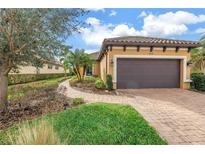 Charming single-Gathering home featuring a well-manicured lawn and a private two-car garage at 10446 Highland Park Pl, Palmetto, FL 34221