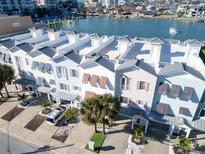 Coastal townhomes featuring private rooftop decks with bay views and covered parking at 130 Brightwater Dr # 5, Clearwater Beach, FL 33767