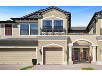 Charming townhome showcasing a private balcony, garages, and well-maintained landscaping at 30045 Southwell Ln, Wesley Chapel, FL 33543
