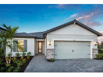 Charming single-story home with well-manicured lawn and a two-car garage with stone column accents at 5732 Bluestar Ct, Lakewood Ranch, FL 34211