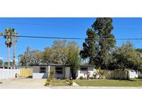 Charming single-story home featuring a well-maintained lawn and freshly painted exterior at 5751 94Th N Ave, Pinellas Park, FL 33782