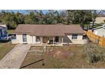 Charming single-story home with a brick driveway, neutral paint, and a cozy front porch perfect for relaxing at 8343 Galewood Cir, Tampa, FL 33615