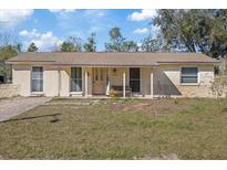 Charming single-story home featuring a cozy front porch and neutral exterior paint at 8343 Galewood Cir, Tampa, FL 33615