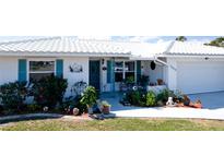 Home with a white tile roof and a tidy front yard at 1320 Bottlebrush Dr, Bradenton, FL 34208