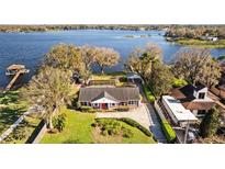 Charming single-story home with a well-maintained lawn and lake view at 14103 Lake Magdalene Blvd, Tampa, FL 33618