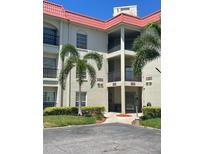 Well-maintained condominium exterior with lush landscaping and covered walkways at 2700 Bayshore Blvd # 2308, Dunedin, FL 34698