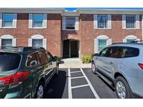 A brick condo building with white trim windows and assigned parking at 3934 37Th S St # 36, St Petersburg, FL 33711