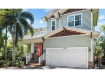 Charming two-story home featuring a well-manicured lawn, two-car garage, and inviting front porch at 4603 S Bartlett St, Tampa, FL 33611