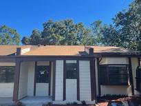 Charming home featuring neutral paint, dark brown trim, and a new roof at 10367 Councils Way, Temple Terrace, FL 33617