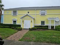 Charming yellow townhome featuring a well-manicured lawn and inviting entrance at 122 Pompano Se Dr # A, St Petersburg, FL 33705