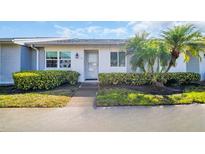 Charming single-story home with well-maintained landscaping, including a walkway to the front door at 3401 Stonehaven E Ct # A, Palm Harbor, FL 34684