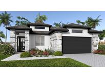 Charming single-story home featuring stone accents, a two-car garage, and lush tropical landscaping at 3724 109Th Street East, Palmetto, FL 34221