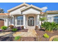Inviting front entrance with double doors, stone walkway, and lush landscaping at 3819 Brooksworth Ave, Tarpon Springs, FL 34688