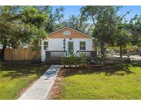 Charming one-story home with a manicured lawn, light blue door, and inviting front porch at 4944 28Th S Ave, Gulfport, FL 33707