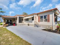 Well maintained single-Gathering home with spacious carport and tidy landscaping at 807 Saint Charles Dr, Tarpon Springs, FL 34689
