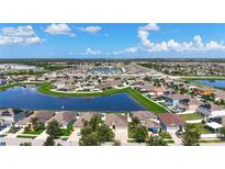 Wide aerial view of a beautiful community centered around a large pond on a bright, sunny day at 924 Peregrine Hill Pl, Ruskin, FL 33570
