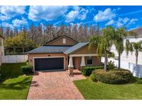 Charming one-story home with manicured lawn, brick driveway, and a well-kept garden at 19476 Paddock View Dr, Tampa, FL 33647
