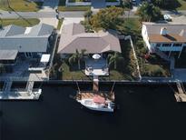 Waterfront home featuring a private boat dock and a spacious patio, perfect for outdoor entertaining at 4108 Daisy Dr, Hernando Beach, FL 34607