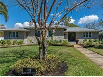 Beautiful stone house with mature landscaping, sidewalk, and a well-manicured green lawn at 524 Park S St, St Petersburg, FL 33707